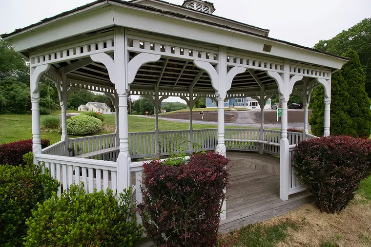 The lawn in front of the motel with the white gazebo